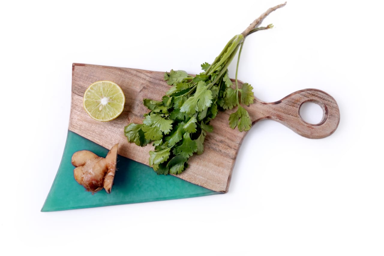 Wooden cutting board on a kitchen counter." "Close-up of a bamboo cutting board." "Rectangular cutting board with knife marks." "Chopping vegetables on a plastic cutting board." "Clean and empty cutting board ready for use.